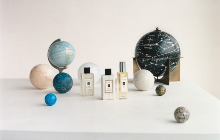 image of jo malone london boxes stacked with a miniature cologne, travel candle and travel size body cream